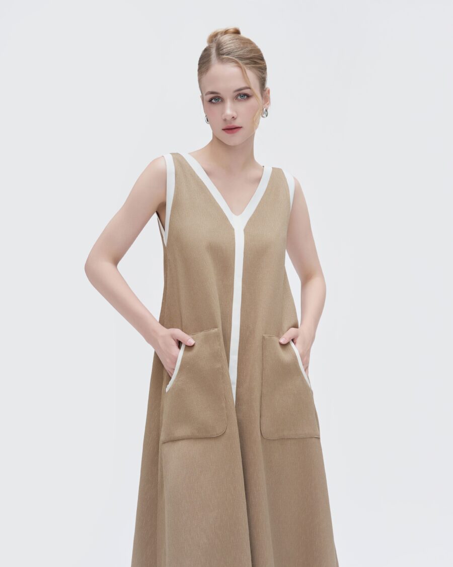 Vintage-inspired brown dress featuring white trim along the neckline