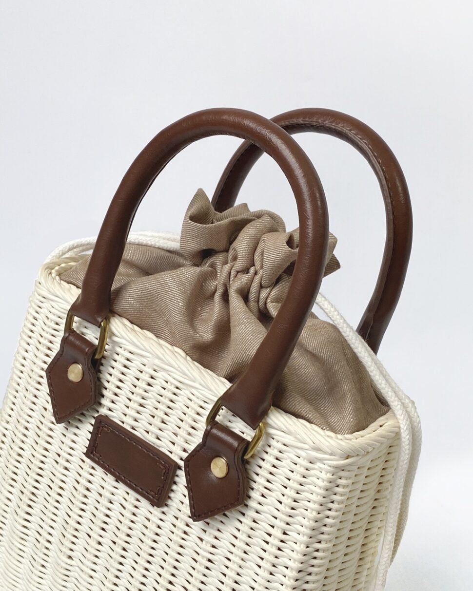 Vintage-style drawstring bag crafted from natural yarn and rattan